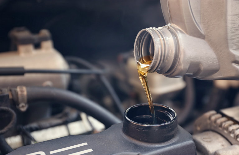Oil being poured into a Mazda3