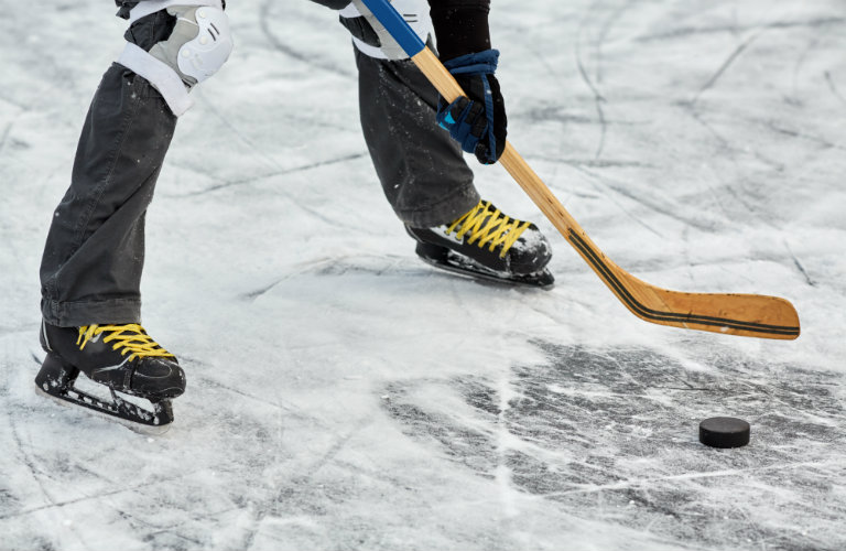 Legs-of-hockey-player-about-to-hit-puck