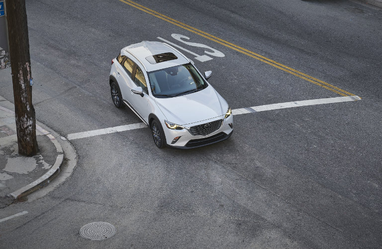 Birds-eye-view-of-2018-Mazda-CX-3-turning-corner-on-city-street