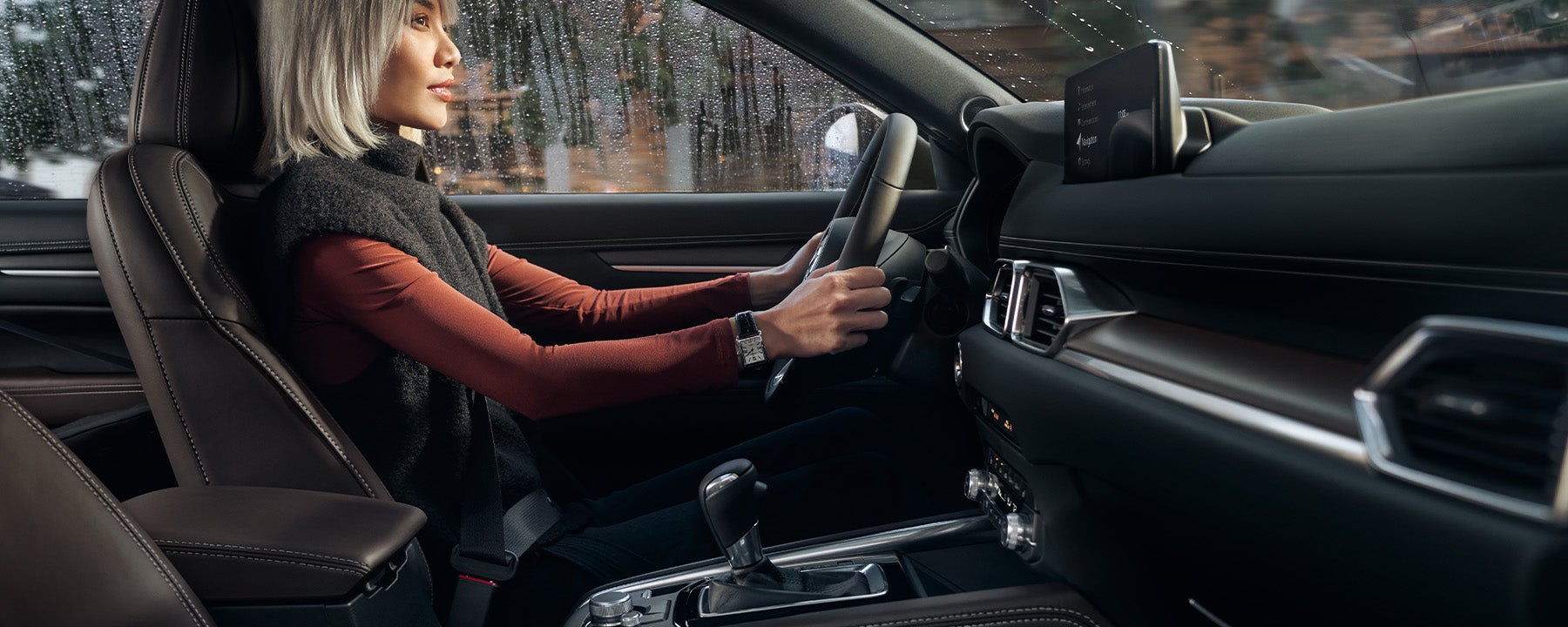 A woman driving the 2025 Mazda CX-5
