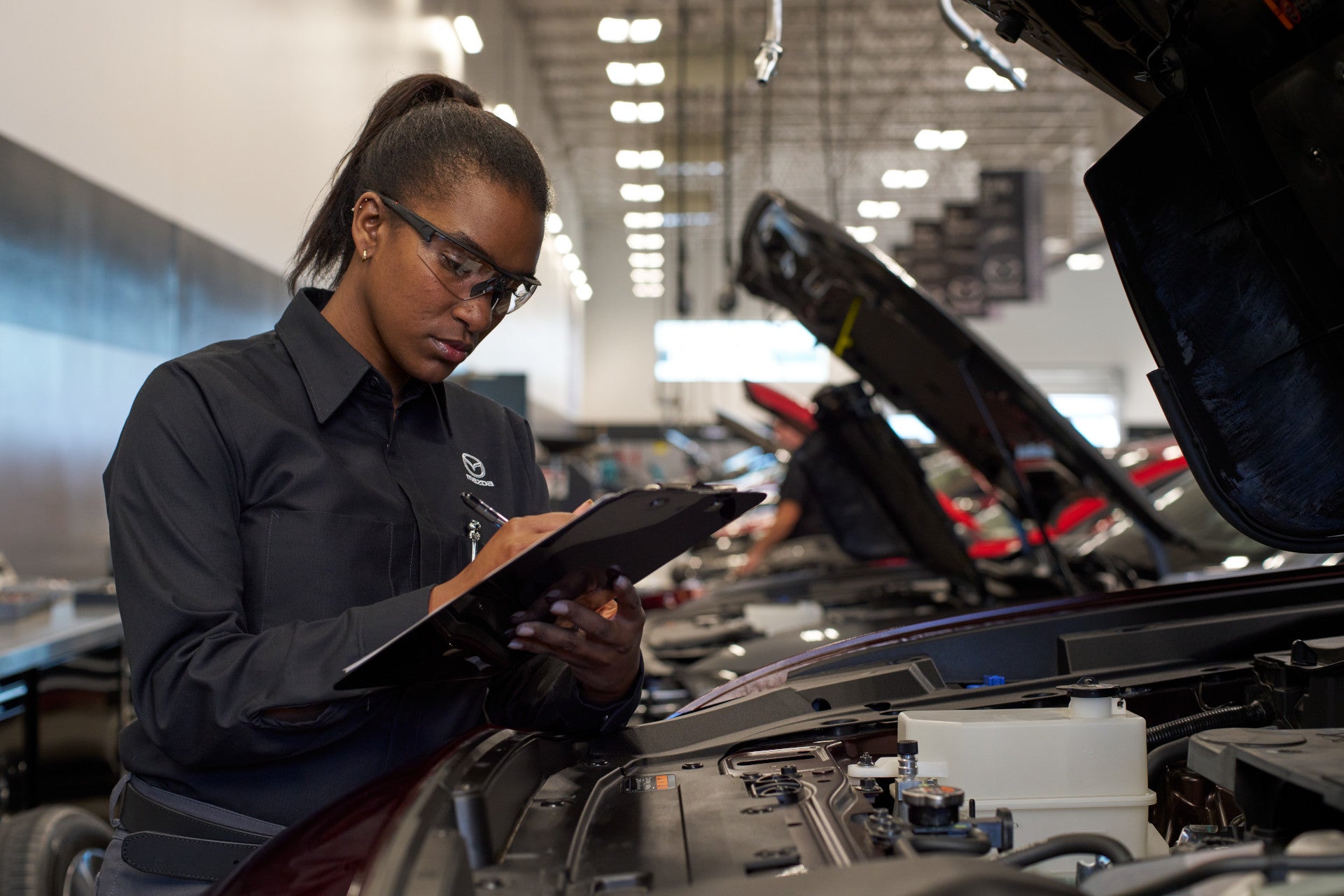 A Mazda technician looking over a checklist