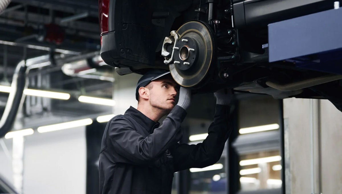 Technician Servicing the Wheels of a Mazda Vehicle