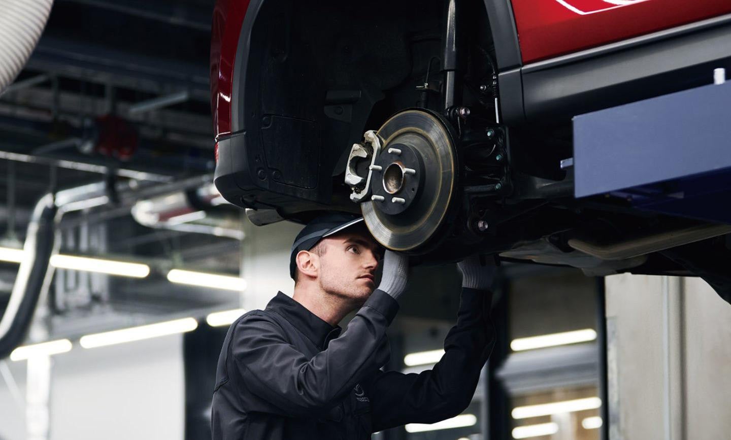A Mazda Technician checking on brake warning signs