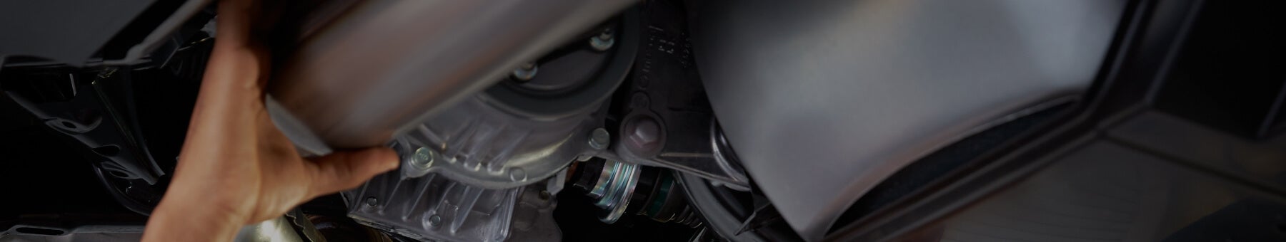 Mechanic fixing a Mazda catalytic converter