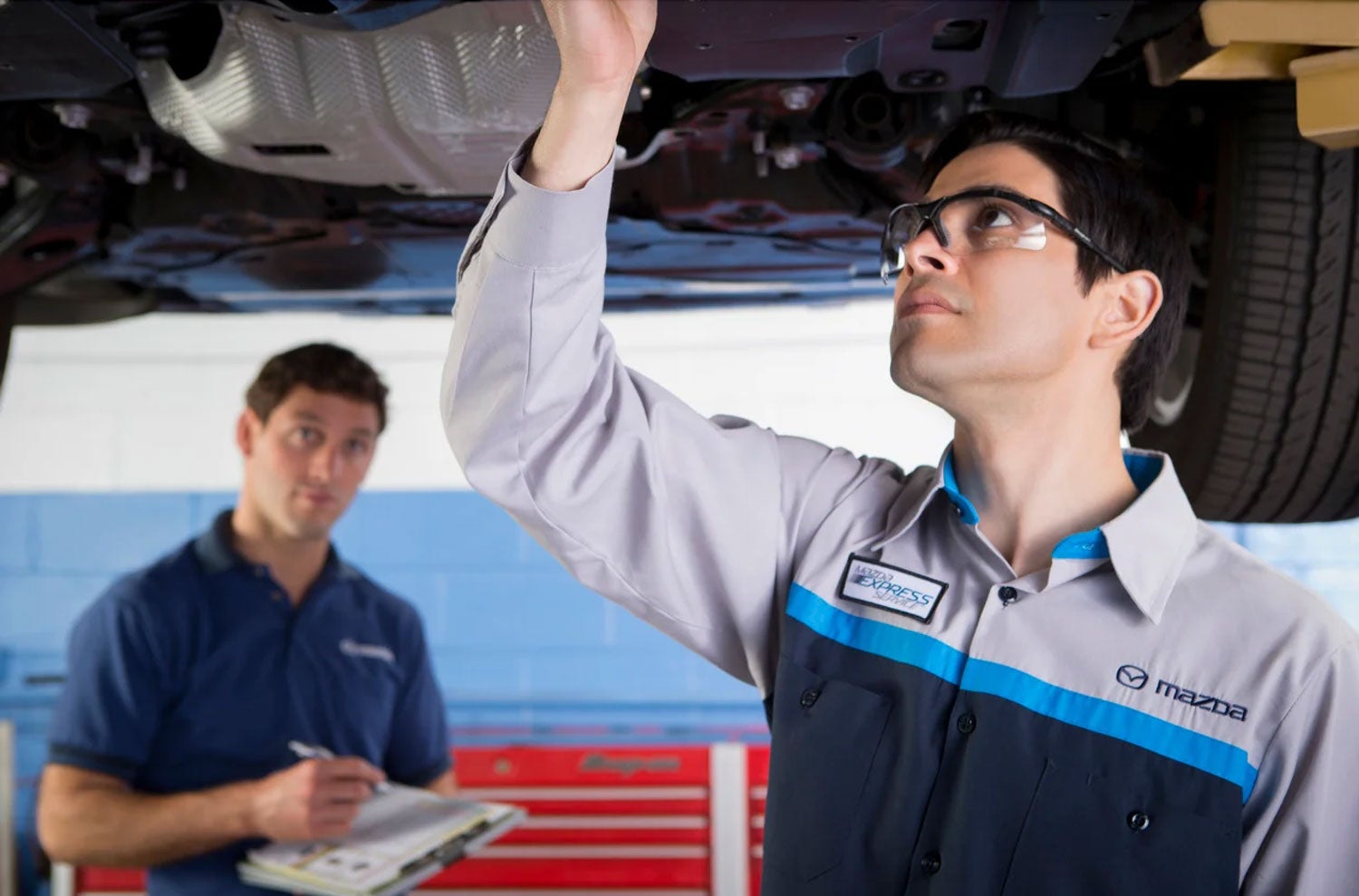 Mazda mechanic performing high-mileage maintenance
