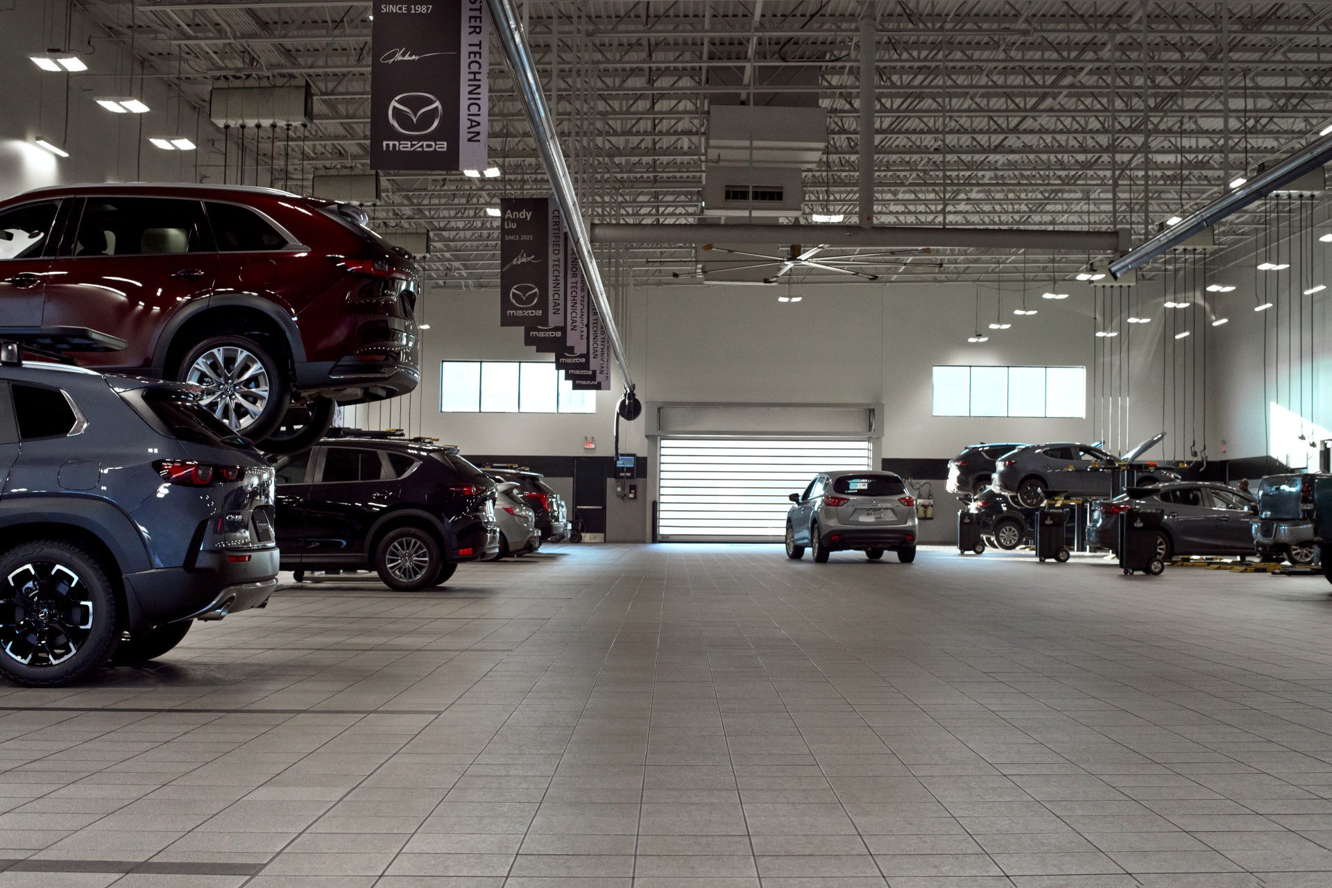 Mazda vehicles on a service lift in the shop